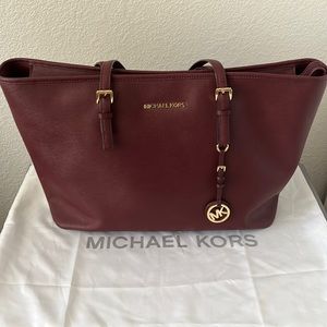 Michael Kors Jet Set Travel medium multi functional tote in merlot leather.